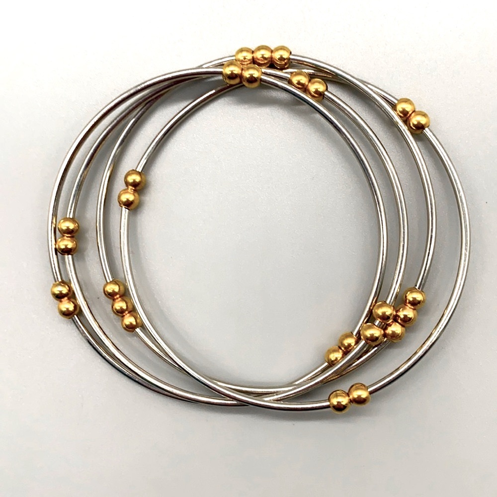Stainless steel and gold accented rollo-bracelet in medium to large wrist size